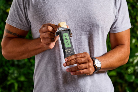 Person holding a rosemary olive oil SVRY protein bar