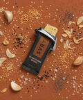 SVRY Everything Bagel Protein Bar on a surface with spices and seasonings