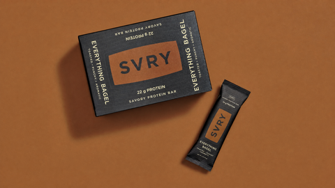 SVRY protein bar packaging on a brown background