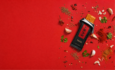 SVR taco seasoning packet on a red background with spices and herbs.