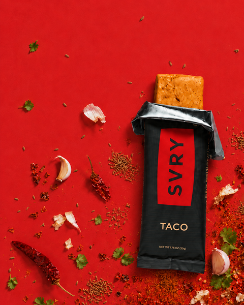 SVRY Taco protein bar on a red background with spices and herbs